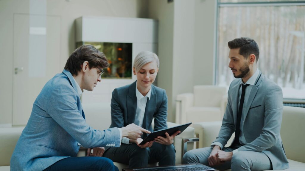 pexels-photo-36765732-36765732 Three professionals engaging in a business meeting in a modern office setting.